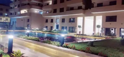 a swimming pool in front of a building at night at Luxury Family Duplex in the Best Area of Marrakech with Pool and Garden in Marrakech
