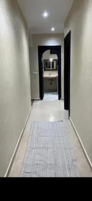 an empty hallway with a rug on the floor at Cozy appartment in Marrakech