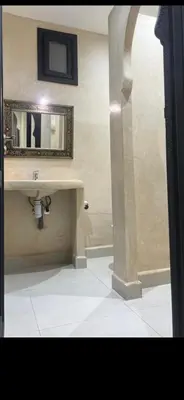a bathroom with a sink and a mirror on the wall at Cozy appartment in Marrakech