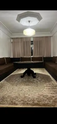 a living room with a couch and a table at Cozy appartment in Marrakech