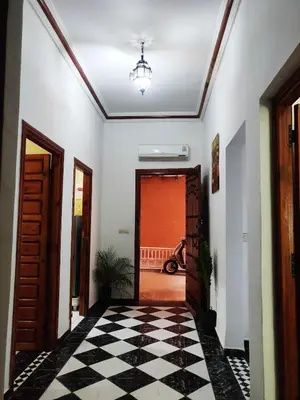 a hallway with a black and white checkered floor at APPARTEMENT DAR MARRAKECh G27 N7 in Marrakech