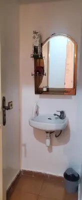 a bathroom with a sink and a mirror on the wall at Well-equipped apartment for rent in Marrakech