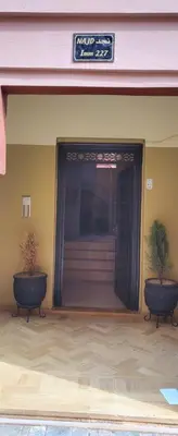 two potted plants sitting in front of a building at Well-equipped apartment for rent in Marrakech