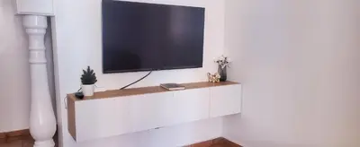 a flat screen tv on a white wall at Well-equipped apartment for rent in Marrakech