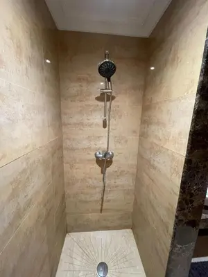 a shower with a shower head in a bathroom at appartement luxueuse in Marrakech
