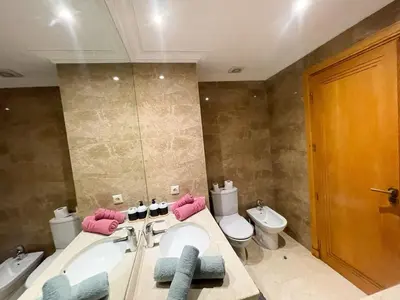 a bathroom with a sink and a toilet and a tub at appartement luxueuse in Marrakech