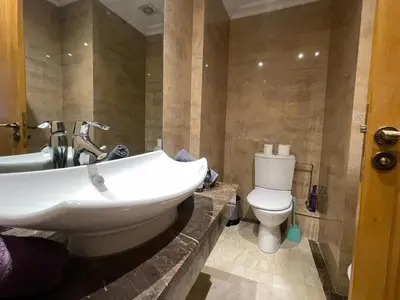 a bathroom with a sink and a toilet at appartement luxueuse in Marrakech