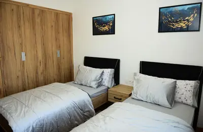 a bedroom with two beds and a wooden wall at Welcome Home! in Marrakech