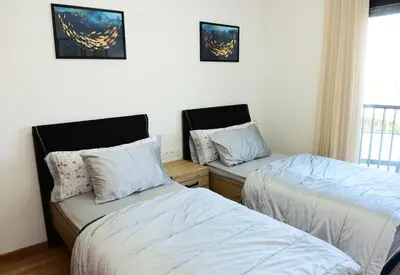 a bedroom with two beds and a window at Welcome Home! in Marrakech