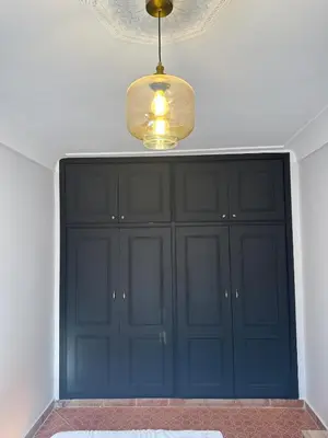 a large black cabinet in a room with a ceiling at Calm Oasis with Private Terrace in Marrakech