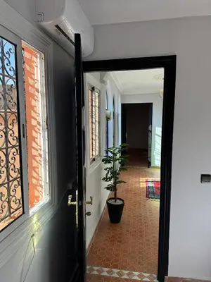 an open door to a hallway with a potted plant at Calm Oasis with Private Terrace in Marrakech