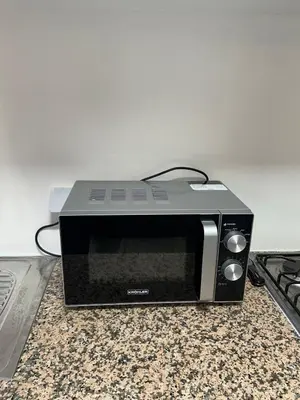 a microwave oven sitting on top of a counter at Calm Oasis with Private Terrace in Marrakech