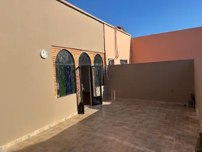 a building with two arched windows and a wall at Calm Oasis with Private Terrace in Marrakech