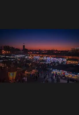 a crowd of people at a market at night at Calm Oasis with Private Terrace in Marrakech