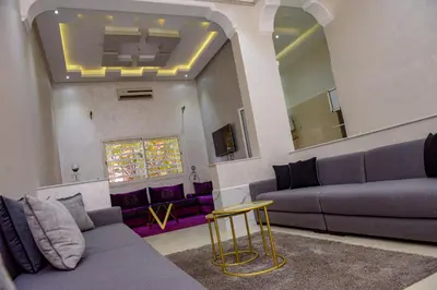 a living room with purple couches and a mirror at Marrakech in Marrakech