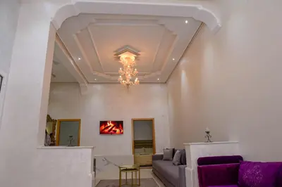 a living room with a couch and a chandelier at Marrakech in Marrakech