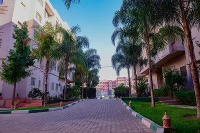a cobblestone street with palm trees and buildings at Marrakech in Marrakech