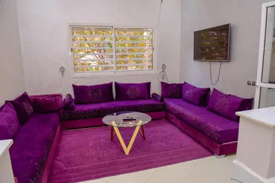 a living room with a purple couch and a table at Marrakech in Marrakech