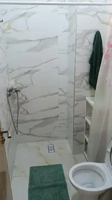 a bathroom with a toilet and a glass shower at marrakech mountazah al jadid in Marrakech