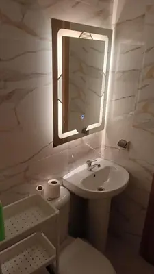 a white bathroom with a sink and a mirror at marrakech mountazah al jadid in Marrakech