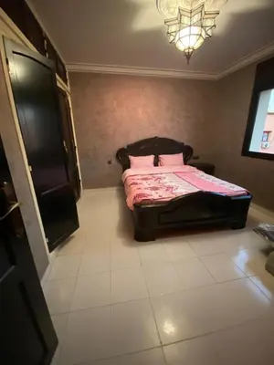 a bedroom with a bed with pink pillows on it at Marrakech gliz in Marrakech