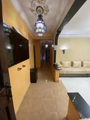 a hallway with a room with two beds and a chandelier at Marrakech gliz in Marrakech