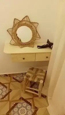 a dressing table with a mirror on top of it at الراحة والسلامة مراكش in El Gouassem