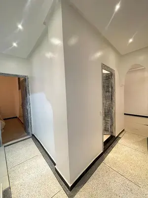 an empty room with a white wall and a doorway at Modern et calme a Marrakech in Marrakech