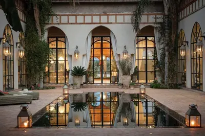a building with a pool of water in front of it at Daba Riads in Marrakech