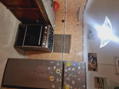 a kitchen with a microwave and a refrigerator at amazing home and amazing rooftop in Marrakech