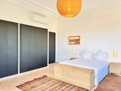 a bedroom with a large white bed and a rug at Villa Zaria Marrakech Heated Pool Family Friendly 25 Min To Medina in Marrakech