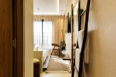 a room with a hallway with a living room at Suite cosy en hypercentre in Marrakech