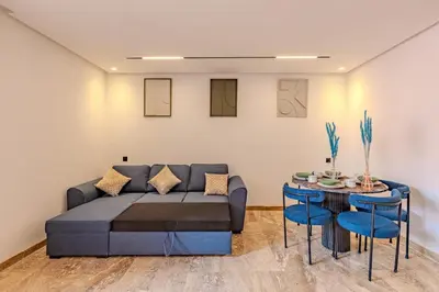 a living room with a couch and a table at Studio Ali gueliz in Marrakech