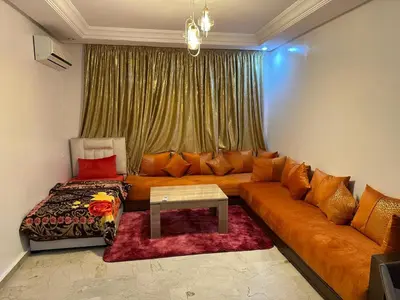a living room with a couch and a table at l'évasion 8 face gare CTM Hivernage a 10mn de l'aéroport in Marrakech
