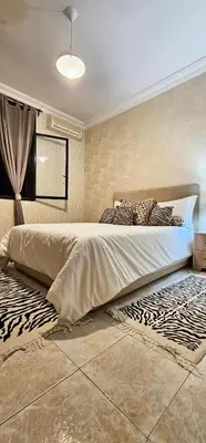 a bedroom with a large bed with zebra pillows at Luxury apartment in Gueliz, near the Majorelle Garden and Yves Saint Laurent Museum in Marrakech