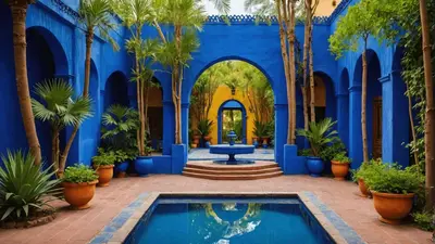 a blue building with a swimming pool and palm trees at Luxury apartment in Gueliz, near the Majorelle Garden and Yves Saint Laurent Museum in Marrakech
