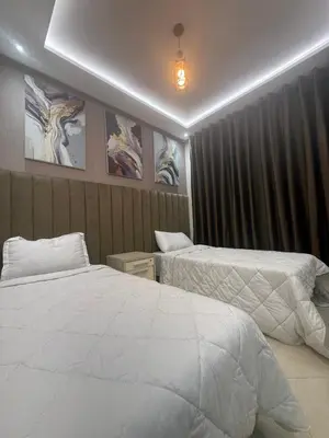 a hotel room with two beds and a window at Séjour haut de gamme lit king TV cinéma 65 in Marrakech