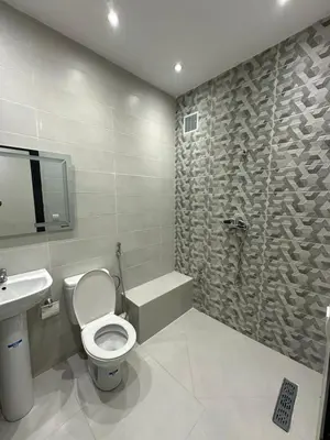 a bathroom with a toilet and a sink and a shower at Séjour haut de gamme lit king TV cinéma 65 in Marrakech