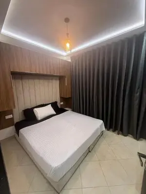a bedroom with a large bed in a room at Séjour haut de gamme lit king TV cinéma 65 in Marrakech