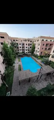 a swimming pool in the middle of a building at Riad jawhara in Marrakech