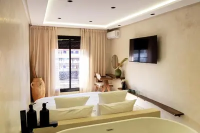 a bedroom with a bed and a television on the wall at Suite luxueuse avec baignoire ouverte in Marrakech