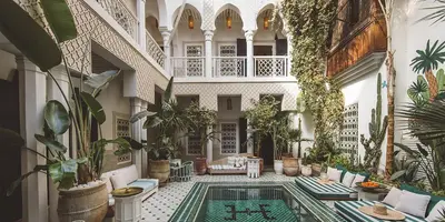 a courtyard with a pool in a building with plants at rid kalim in Marrakech