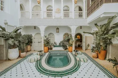 a swimming pool in a large building with plants at rid kalim in Marrakech