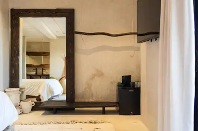 a mirror in a room with a bed and a bedroom at Suite avec vue époustouflante sur les jardins majorelle in Marrakech
