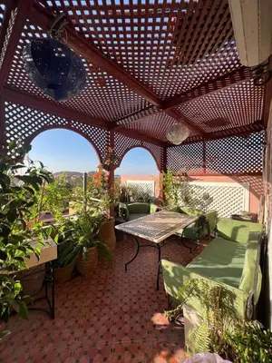 an outdoor patio with a table and chairs at Gueliz Boutique Apartment in Marrakech