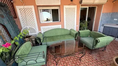 a living room with a couch and a chair at Gueliz Boutique Apartment in Marrakech