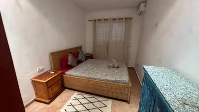 a small bedroom with a bed and a dresser at Gueliz Boutique Apartment in Marrakech