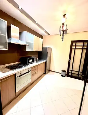 a kitchen with a refrigerator and a stove at L'Escapade Douce Marrakech in Marrakech