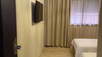 a bedroom with a bed and a television and a window at L'Escapade Douce Marrakech in Marrakech