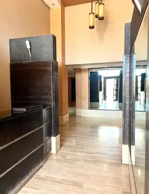 a lobby with a wooden floor and a building at L'Escapade Douce Marrakech in Marrakech